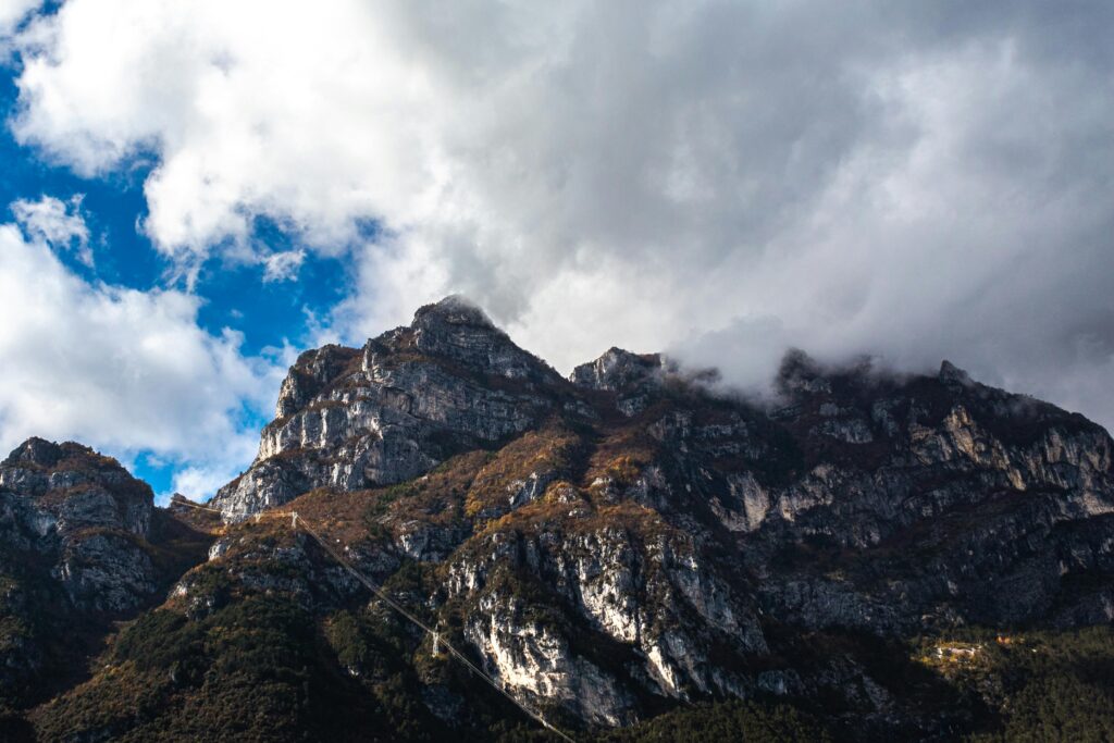 Clouds cover the rocky peaks of mountains near Riva del Garda, Italy.